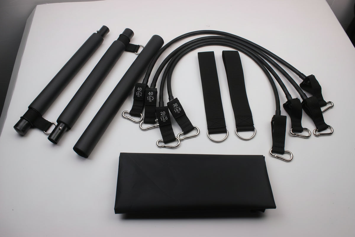 Multifunctional Pilates bar with resistance bands and foot straps